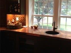Home bar with top mounted hammered copper sink