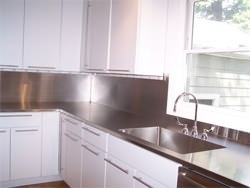 Stainless steel #4 finish counter top with high backsplash and integrated sink