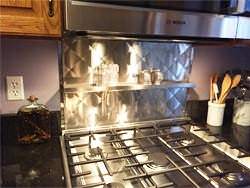 Quilted back splash in stainless steel with shelf