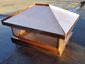 Copper chimney cap featuring standing seam hip roof panels with a flat portion - view 2