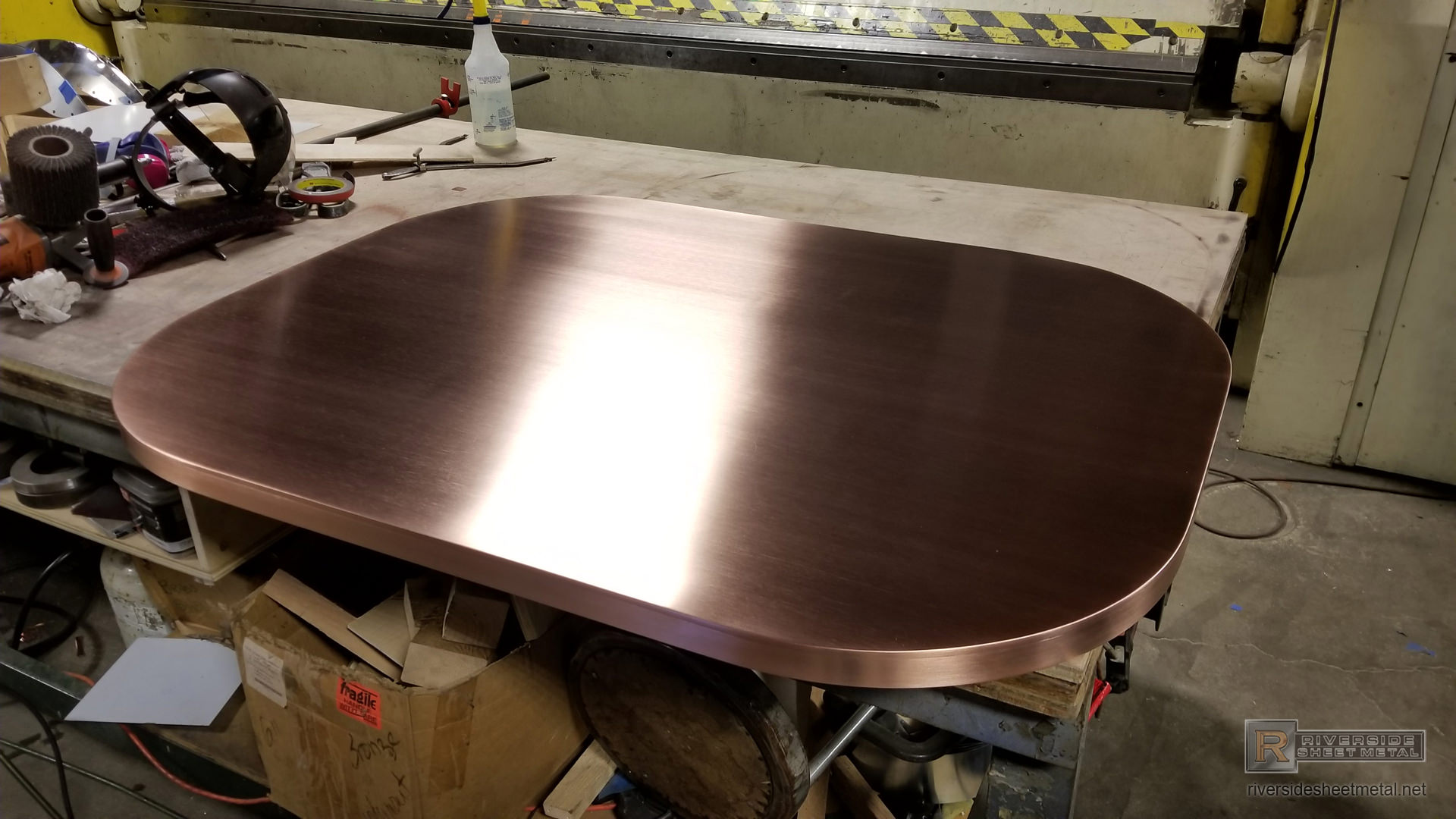 https://www.riversidesheetmetal.net/counter-tops/copper/oval-brushed-copper-table-top-2_1080.jpg