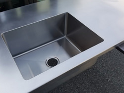 Satin finish stainless steel counter top with integrated sink and back splash