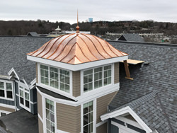 Copper cupola tower - eyebrow roof with finial