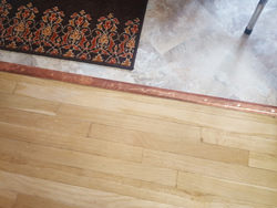 Custom copper threshold transition piece for floor