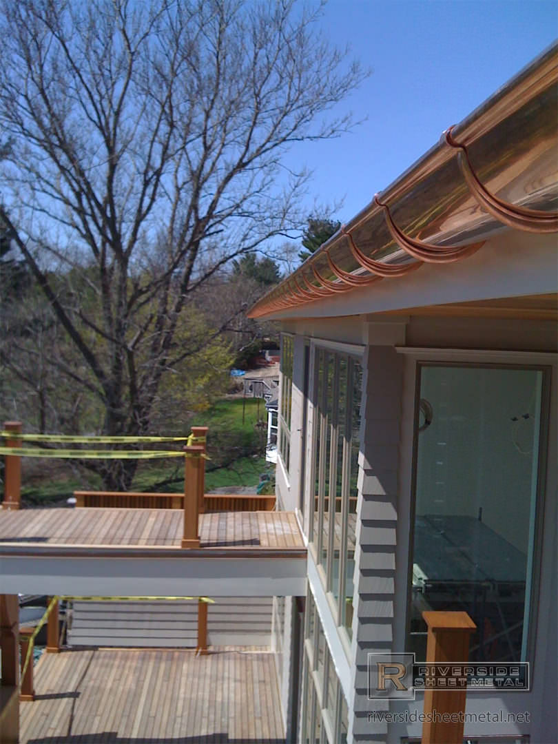 Half round copper gutter installation with undermount hangers