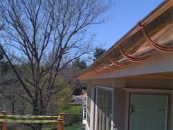 Half round copper gutter installation with undermount hangers