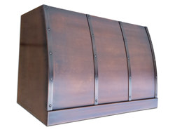 Copper kitchen hood barrel style with an aged patina