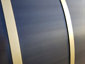 Darkened stainless steel barrel range hood with brass bandings - view 11