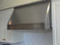 Stainless steel custom hood vent with band and brass rivets installed