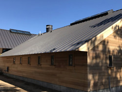 Bronze aluminum kynar standing seam roof with custom chimney cap