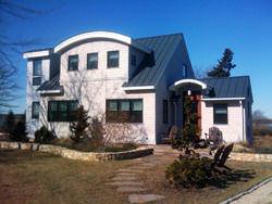 Charcoal gray metal roofing with radius panels