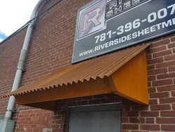 Corrugated corten rusted roof panel installation