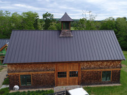 Matte black kynar aluminum metal roofing with cupola and curved panels