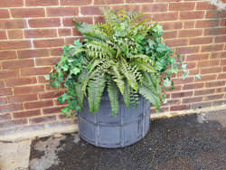 Dark patina lead coated copper planters with grate and rivets