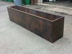 Custom copper flower box with dark patina finish